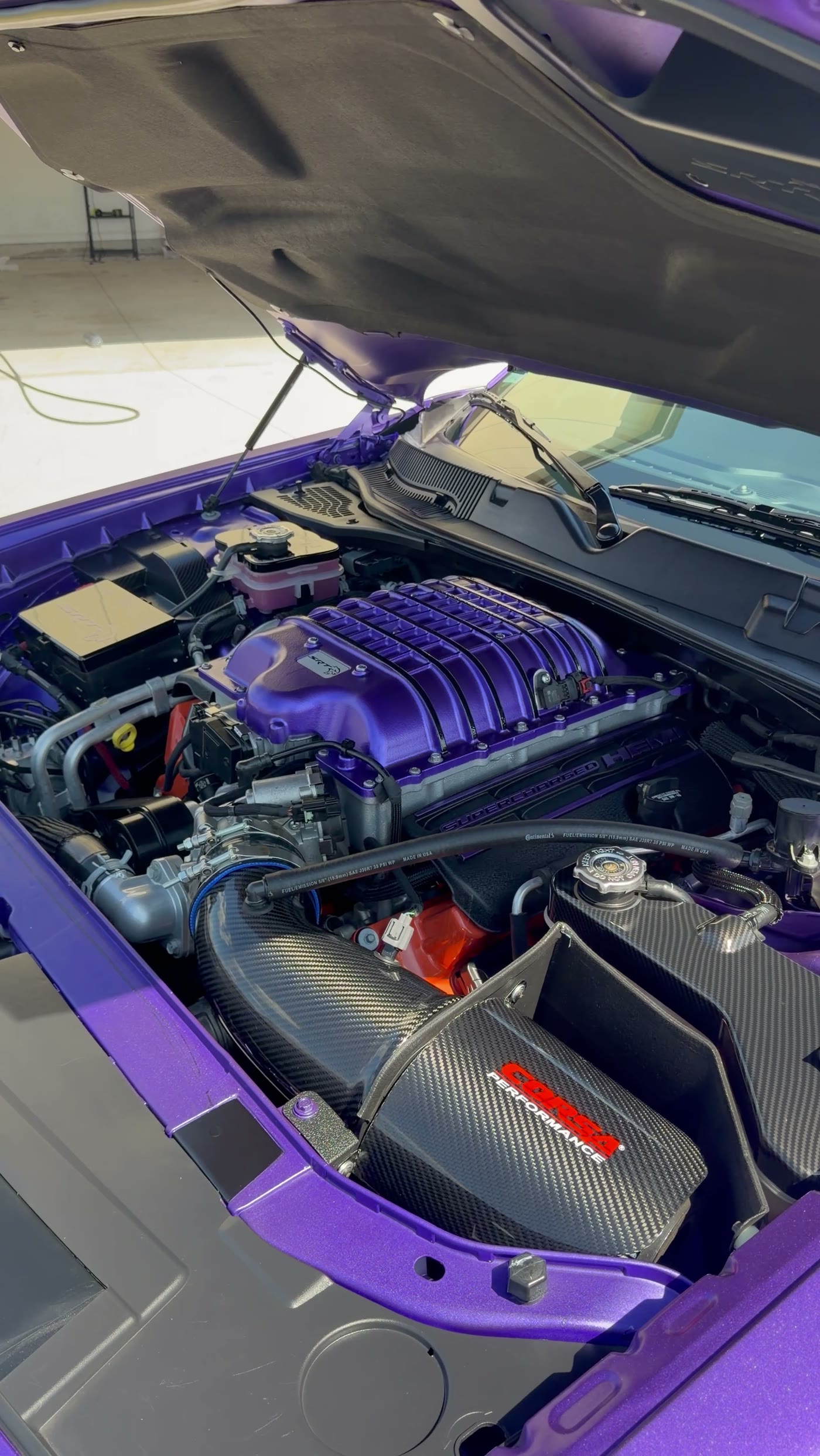 Supercharged engine bay of a Dodge Challenger SRT after detailing